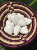 white scolecite hearts in a purple and white basket