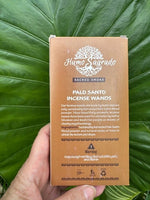 Box of Humo Sagrado Palo Santo Incense Wands held against a green leafy background