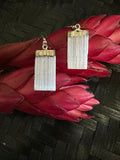 selenite earrings on a black background with a red flower 2