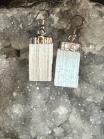 selenite earrings on a clear crystal