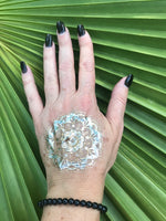 4 mm bead black tourmaline crystal stretch bracelet on a woman's arm with a gold press on tattoo on her hand with black nails against a green palm leaf