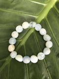 a light blue aquamarine crystal bracelet on a green leaf