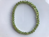 6 mm bead light green peridot crystal stretch bracelet against a white background