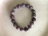 a light purple tumbled lepidolite crystal bracelet on a white background