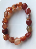 orange tumbled carnelian crystal  bracelet on a white background